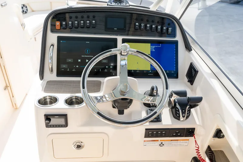 Slide: The Image of 2024 Grady-White Freedom 307 helm with modern controls and dual displays. - 10