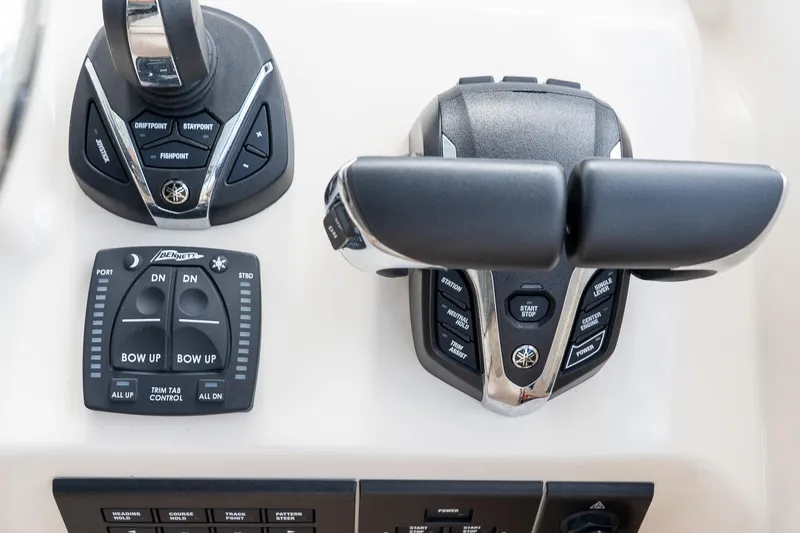 Slide: The Image of 2024 Grady-White Freedom 307 boat controls with joystick and trim tab panel. - 11