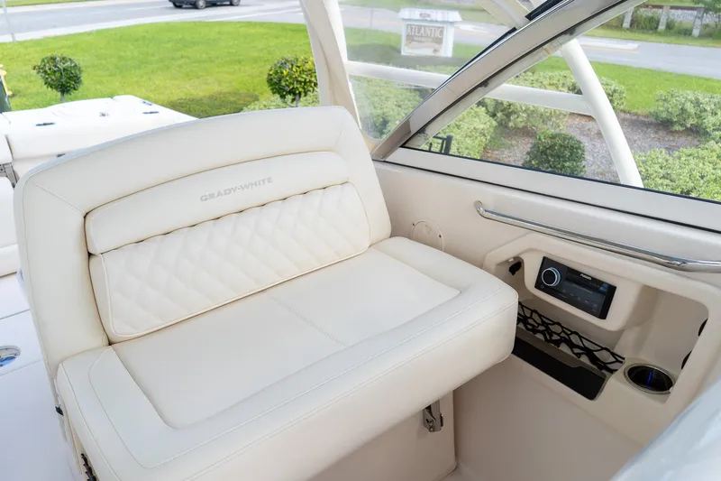 Slide: The Image of 2024 Grady-White Freedom 307 boat interior with luxurious seating and modern controls. - 17