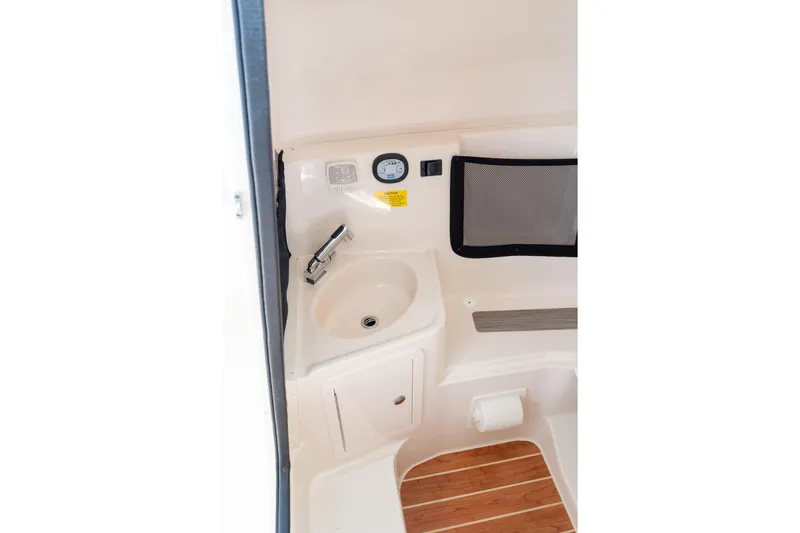 Slide: The Image of 2024 Grady-White Freedom 307 boat interior with sink and wooden flooring. - 20