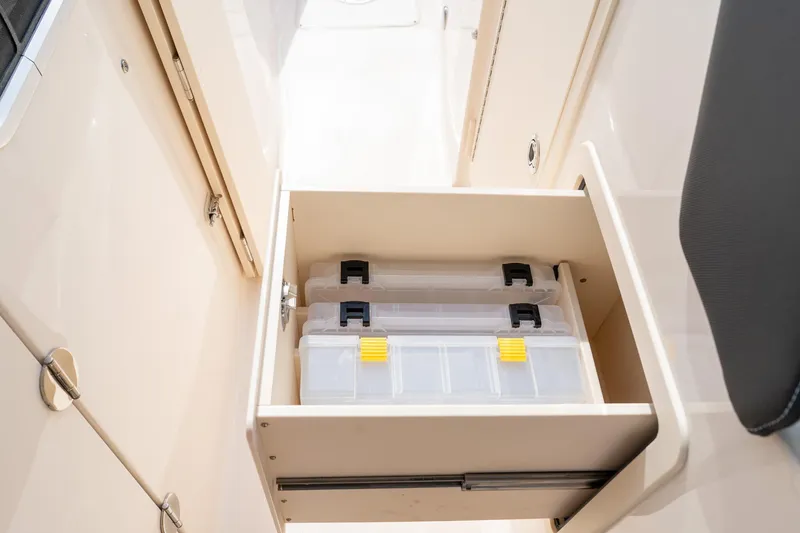 Slide: The Image of 2024 Grady-White Freedom 307 boat storage drawer with organized tackle boxes. - 26