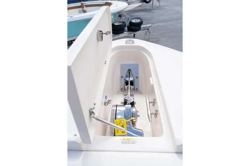Slide: The Image of 2024 Grady-White Freedom 307 anchor locker with open hatch, showcasing anchor and winch system. - 29