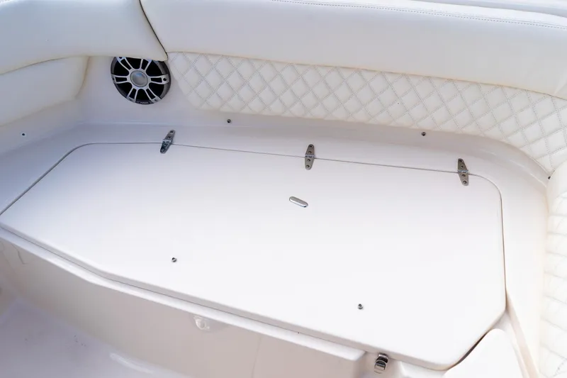 Slide: The Image of 2024 Grady-White Freedom 307 boat interior with white cushioned seating and speaker. - 33