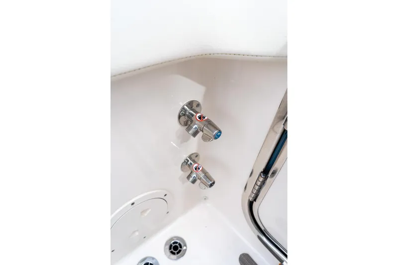 Slide: The Image of 2024 Grady-White Freedom 307 boat shower controls, featuring sleek chrome fixtures. - 36