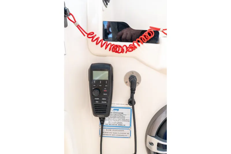 Slide: The Image of 2024 Grady-White Freedom 307 boat communication equipment with red coiled cord and control panel. - 39