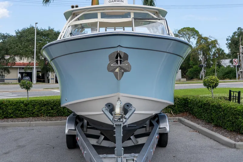 Slide: The Image of 2024 Grady-White Freedom 307 boat on trailer, front view, parked outdoors. - 41