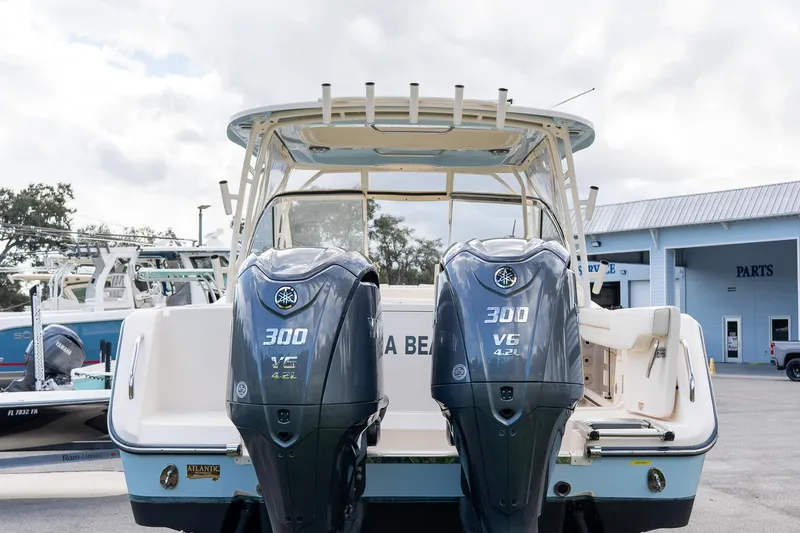 Slide: The Image of 2024 Grady-White Freedom 307 boat with dual Yamaha 300 V6 engines at a marina. - 42