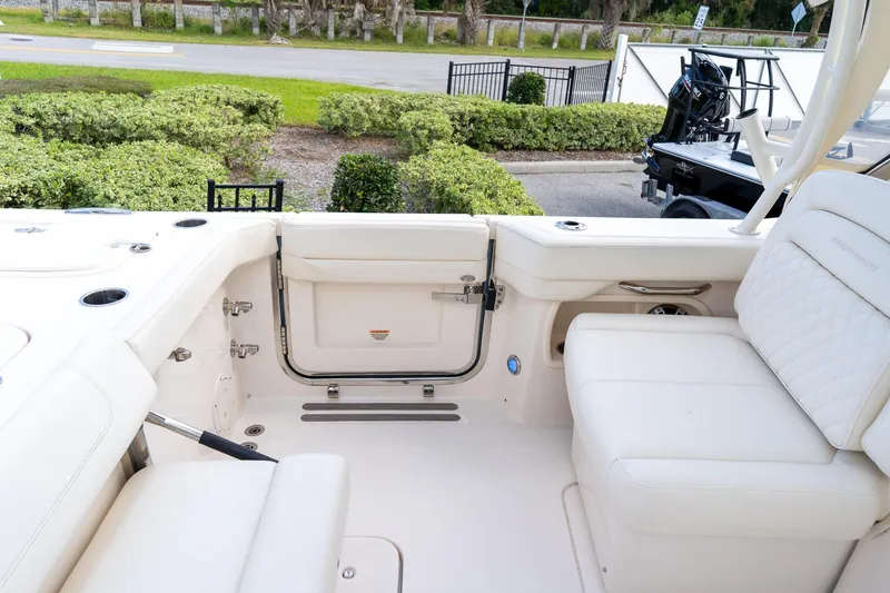 Slide: The Image of 2024 Grady-White Freedom 307 boat interior with white seating and open transom door. - 45