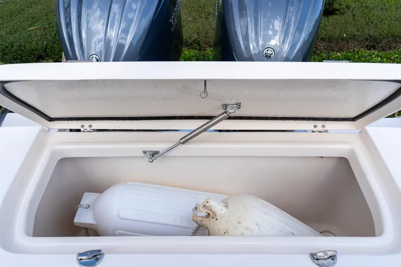 Slide: The Image of Open storage compartment on 2024 Grady-White Freedom 307 boat with fender inside. - 49