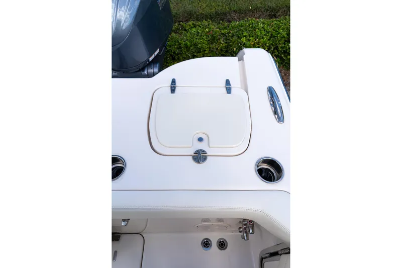 Slide: The Image of 2024 Grady-White Freedom 307 boat deck with storage compartment and cup holders. - 51