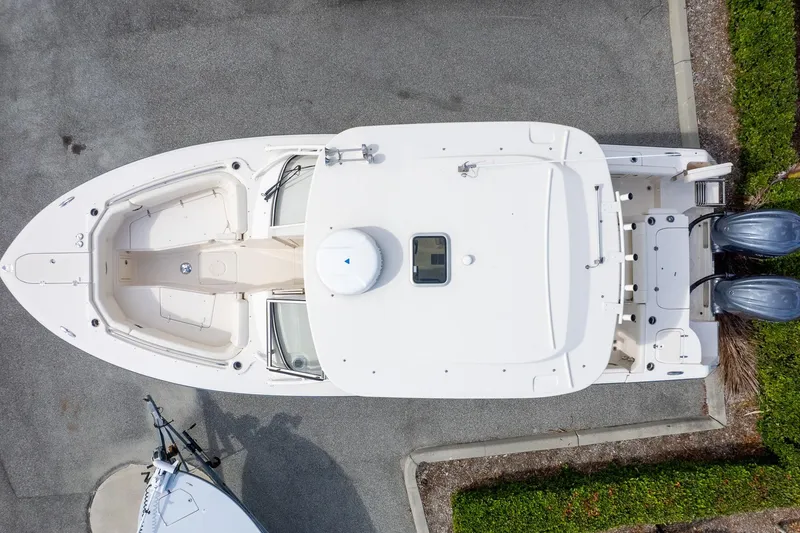 Slide: The Image of 2024 Grady-White Freedom 307 boat, aerial view, parked on pavement. - 6