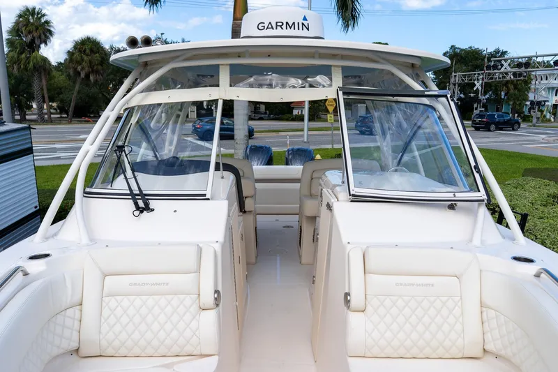 Slide: The Image of 2024 Grady-White Freedom 307 boat interior with Garmin equipment, showcasing luxury seating. - 8