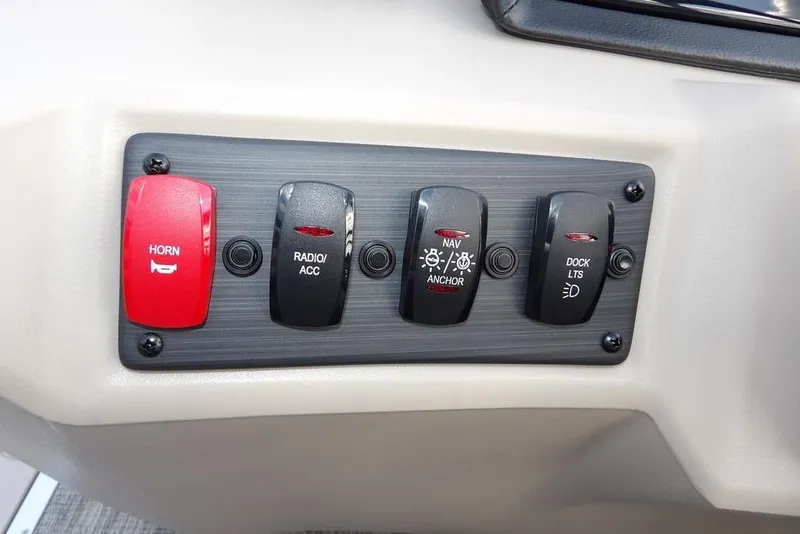 Slide: The Image of Control panel of 2026 Bennington S Swingback 22 SSB with horn, radio, navigation, and dock lights switches. - 21