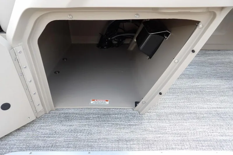 Slide: The Image of Storage compartment of 2026 Bennington S Swingback 22 SSB boat, featuring carpeted flooring. - 25