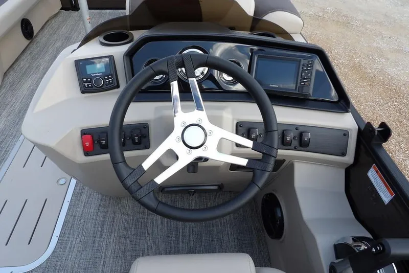 Slide: The Image of 2026 Bennington S Swingback 22 SSB boat dashboard with steering wheel and controls. - 26