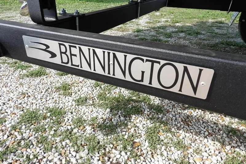 Slide: The Image of Bennington logo on 2026 S Swingback 22 SSB trailer, gravel background. - 45