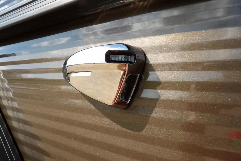 Slide: The Image of 2026 Bennington S Swingback 22 SSB, metallic exterior detail with chrome accent. - 47