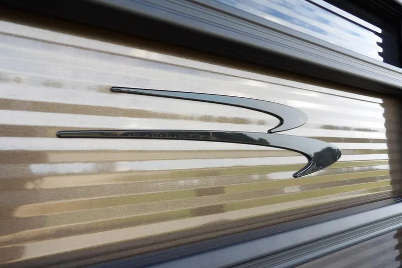 Slide: The Image of 2026 Bennington S Swingback 22 SSB logo on sleek, metallic surface. - 48