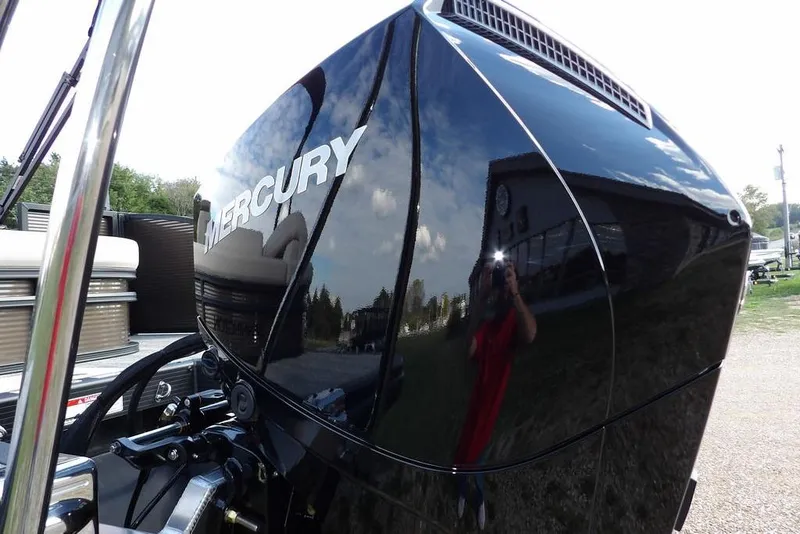 Slide: The Image of 2026 Bennington S Swingback 22 SSB with Mercury engine, reflecting surroundings. - 56