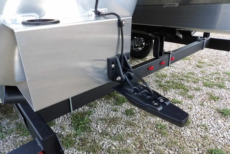Slide: The Image of 2026 Bennington S Swingback 22 SSB trailer hitch and frame on gravel surface. - 57