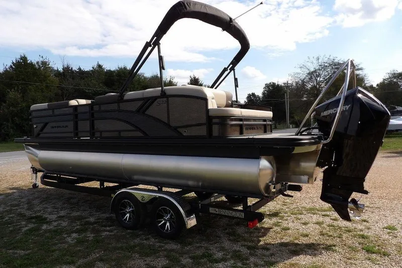 Slide: The Image of 2026 Bennington S Swingback 22 SSB pontoon boat on trailer, featuring Mercury outboard motor. - 9