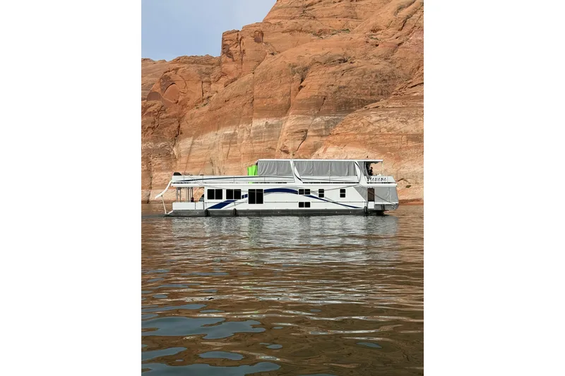 The Image of 2024 Sumerset Mahana Trip #8 houseboat on calm water near red rock cliffs. - 1