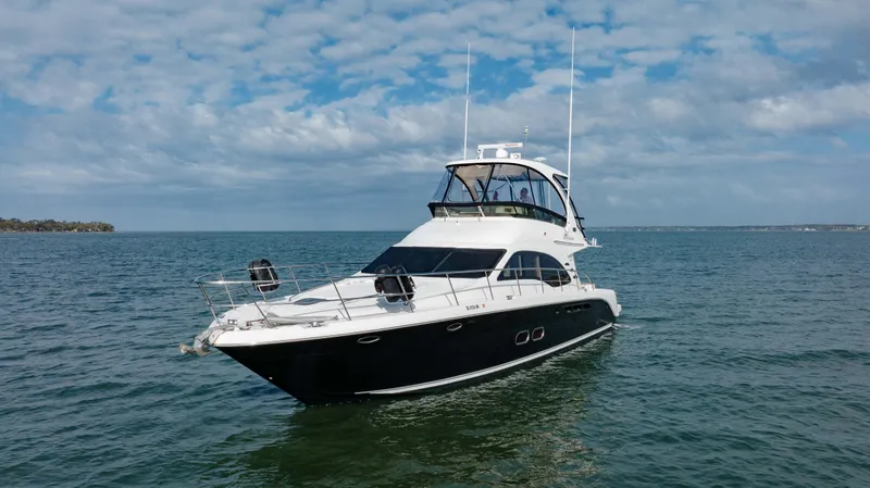 Slide: The Image of 2008 Sea Ray 52 Sedan Bridge yacht cruising on open water. - 11