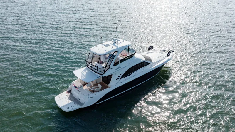 Slide: The Image of 2008 Sea Ray 52 Sedan Bridge yacht cruising on open water. - 12