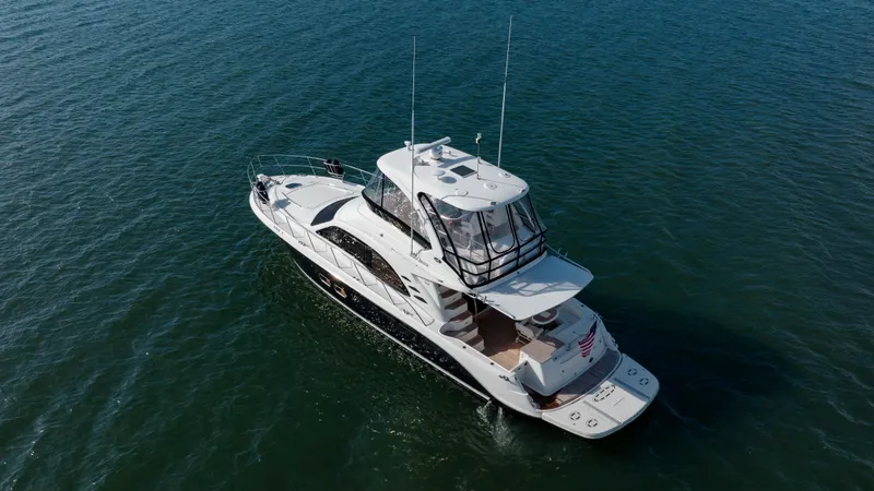 Slide: The Image of 2008 Sea Ray 52 Sedan Bridge yacht cruising on open water. - 13