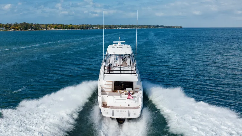 Slide: The Image of 2008 Sea Ray 52 Sedan Bridge cruising on open water. - 14