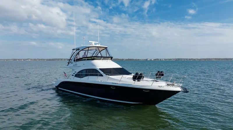 Slide: The Image of 2008 Sea Ray 52 Sedan Bridge yacht on open water under blue sky. - 16