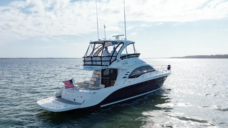 Slide: The Image of 2008 Sea Ray 52 Sedan Bridge yacht cruising on open water. - 17