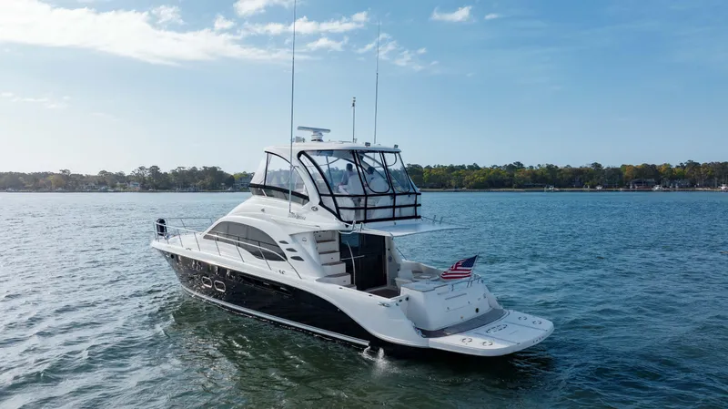 Slide: The Image of 2008 Sea Ray 52 Sedan Bridge yacht cruising on a calm lake. - 19