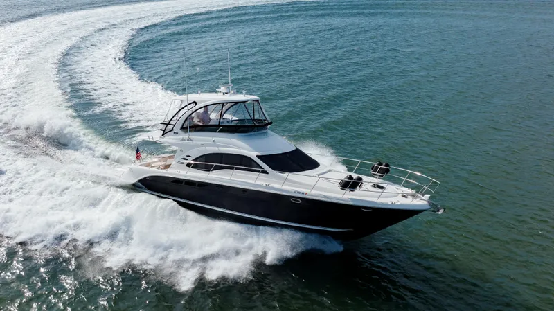 Slide: The Image of 2008 Sea Ray 52 Sedan Bridge yacht cruising on open water. - 2