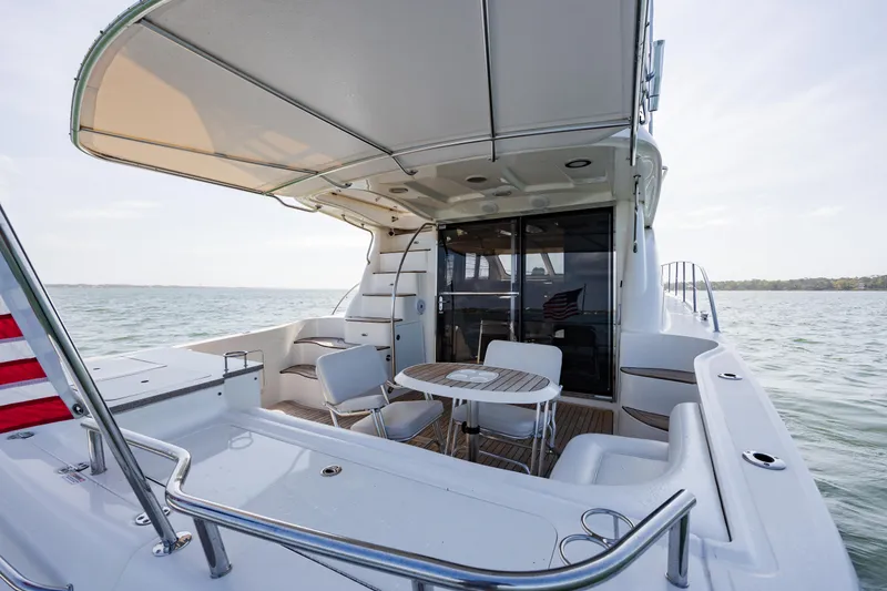 Slide: The Image of 2008 Sea Ray 52 Sedan Bridge yacht with spacious deck and seating area. - 20