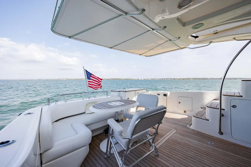 Slide: The Image of 2008 Sea Ray 52 Sedan Bridge yacht deck with seating and ocean view. - 24