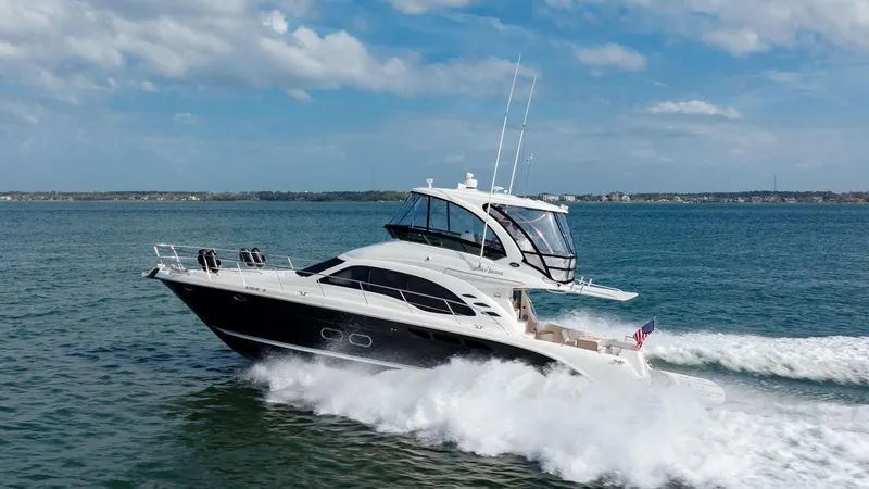 Slide: The Image of 2008 Sea Ray 52 Sedan Bridge yacht cruising on open water. - 3