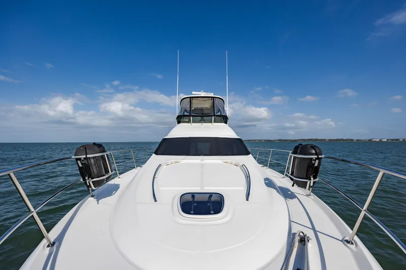 Slide: The Image of 2008 Sea Ray 52 Sedan Bridge yacht on open water under blue sky. - 31