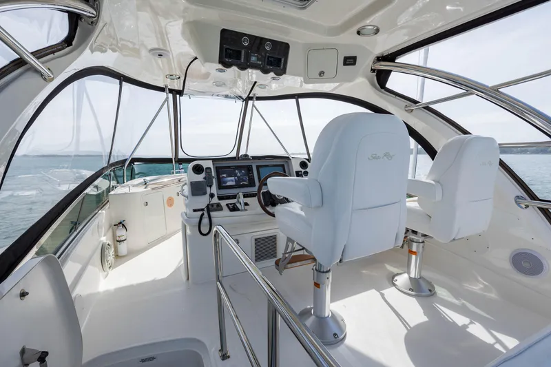 Slide: The Image of 2008 Sea Ray 52 Sedan Bridge helm with dual captain chairs and navigation equipment. - 33