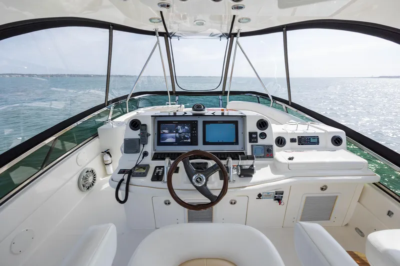 Slide: The Image of 2008 Sea Ray 52 Sedan Bridge helm with navigation equipment and ocean view. - 35
