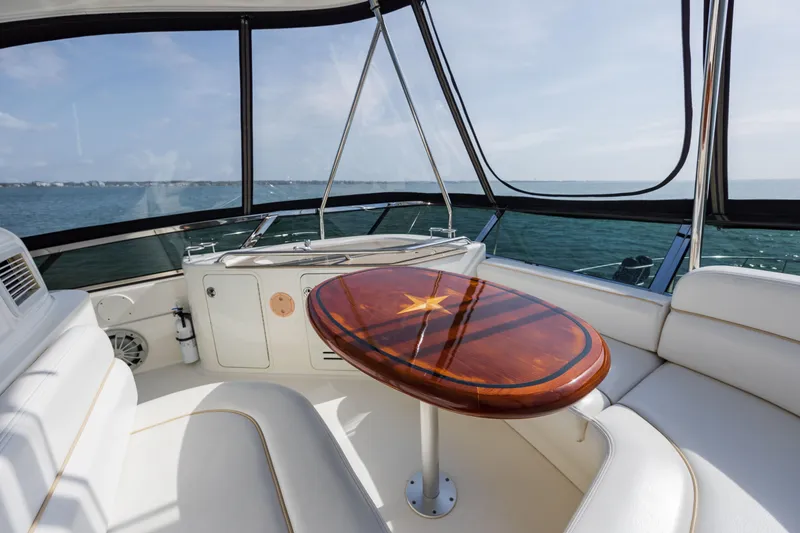 Slide: The Image of Luxurious 2008 Sea Ray 52 Sedan Bridge interior with elegant wood table and ocean view. - 45