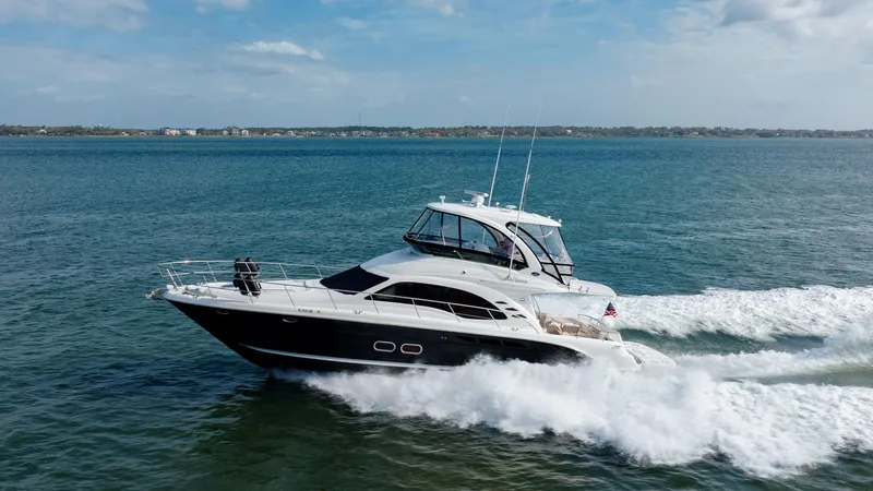 Slide: The Image of 2008 Sea Ray 52 Sedan Bridge yacht cruising on open water. - 5