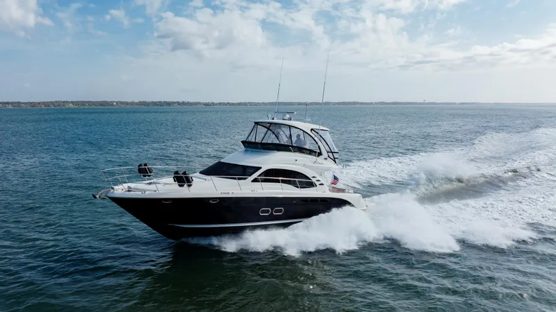 Slide: The Image of 2008 Sea Ray 52 Sedan Bridge yacht cruising on open water. - 6