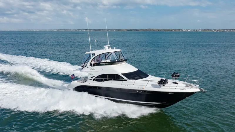 Slide: The Image of 2008 Sea Ray 52 Sedan Bridge yacht cruising on open water. - 7