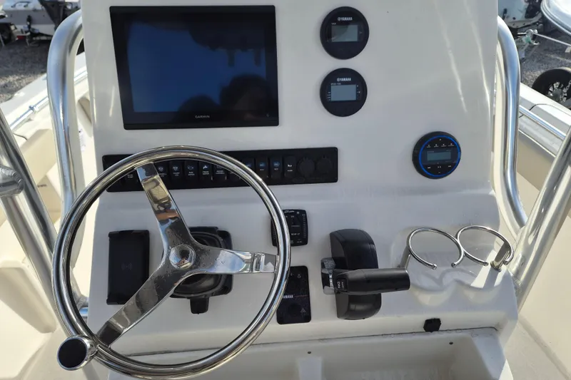 Slide: The Image of 2026 Key West 239 FS boat dashboard with steering wheel and electronic displays. - 10