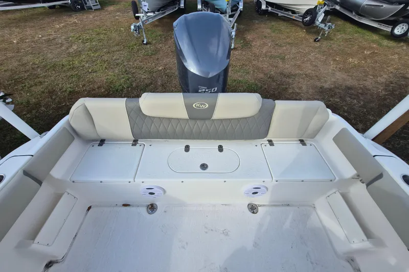 Slide: The Image of 2026 Key West 239 FS boat interior with cushioned seating and motor view. - 11