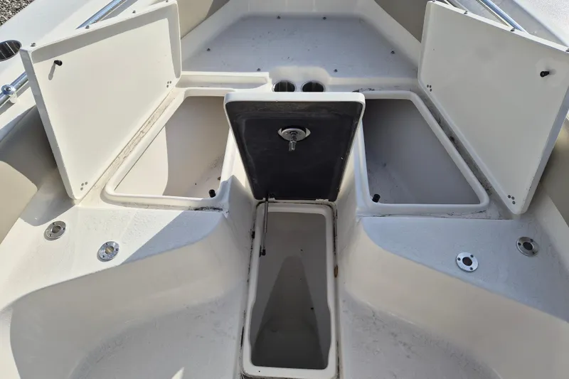 Slide: The Image of Key West 239 FS 2026 boat with open storage compartments. - 14