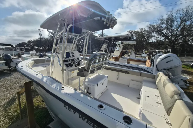Slide: The Image of 2026 Key West 239 FS boat with T-top and seating, displayed outdoors. - 6