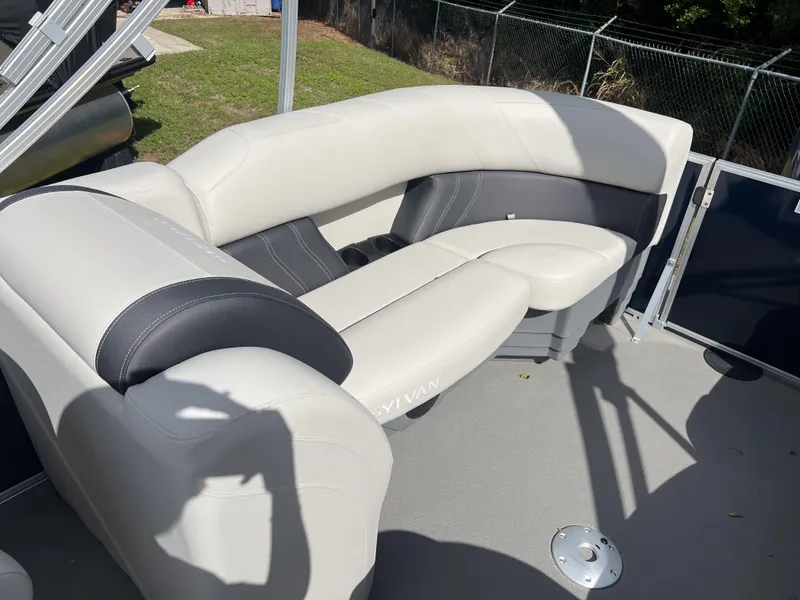 Slide: The Image of 2025 Sylvan Mirage 822 LZ boat interior with white and black seating. - 13