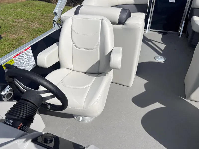 Slide: The Image of 2025 Sylvan Mirage 822 LZ boat interior with white captain's chair and steering wheel. - 8